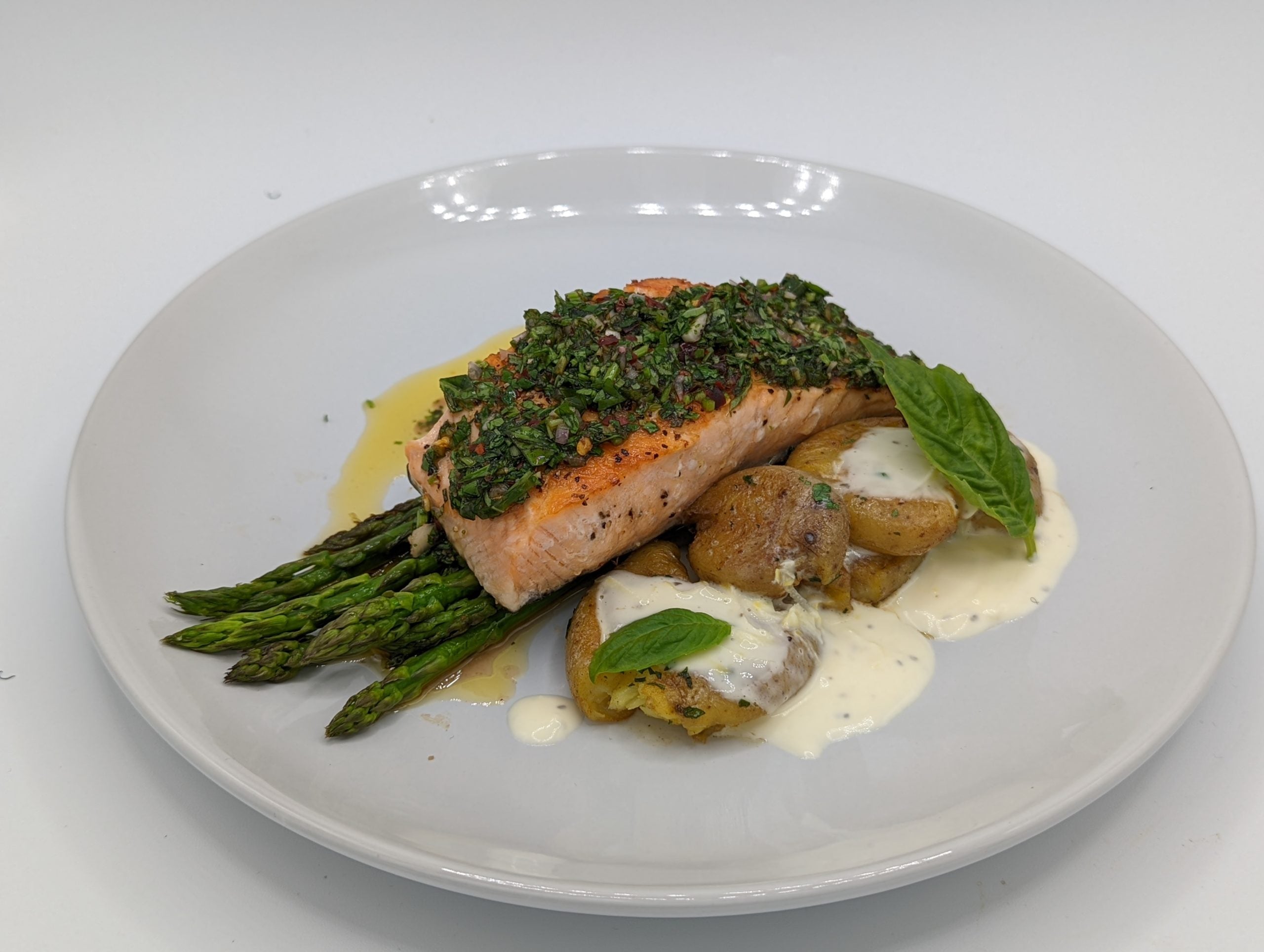 Secret Island Salmon w/ Basil Chimichurri Served with Asparagus & Papas a la Chapa Recipe