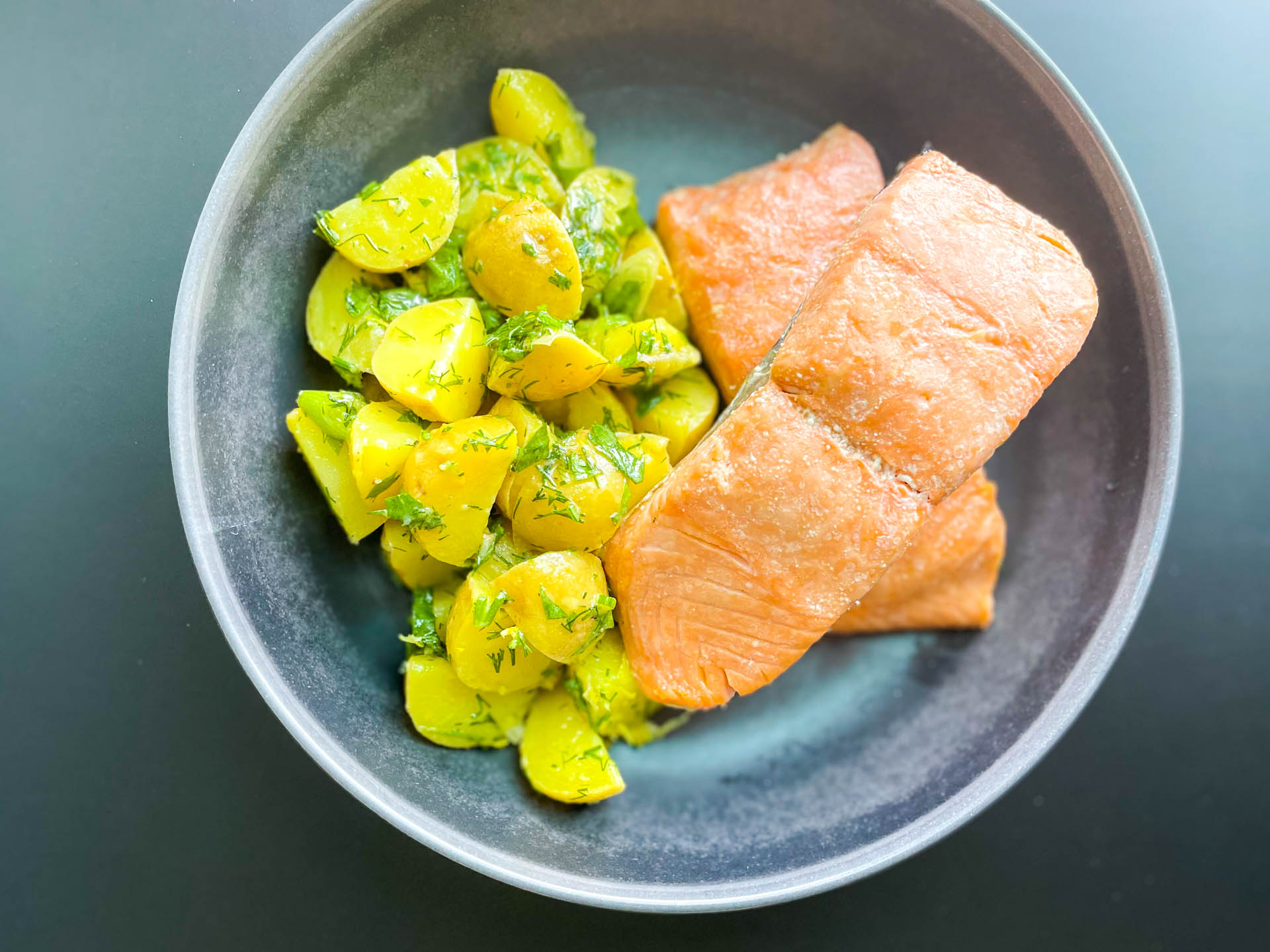 Poached salmon with herb and potato salad.